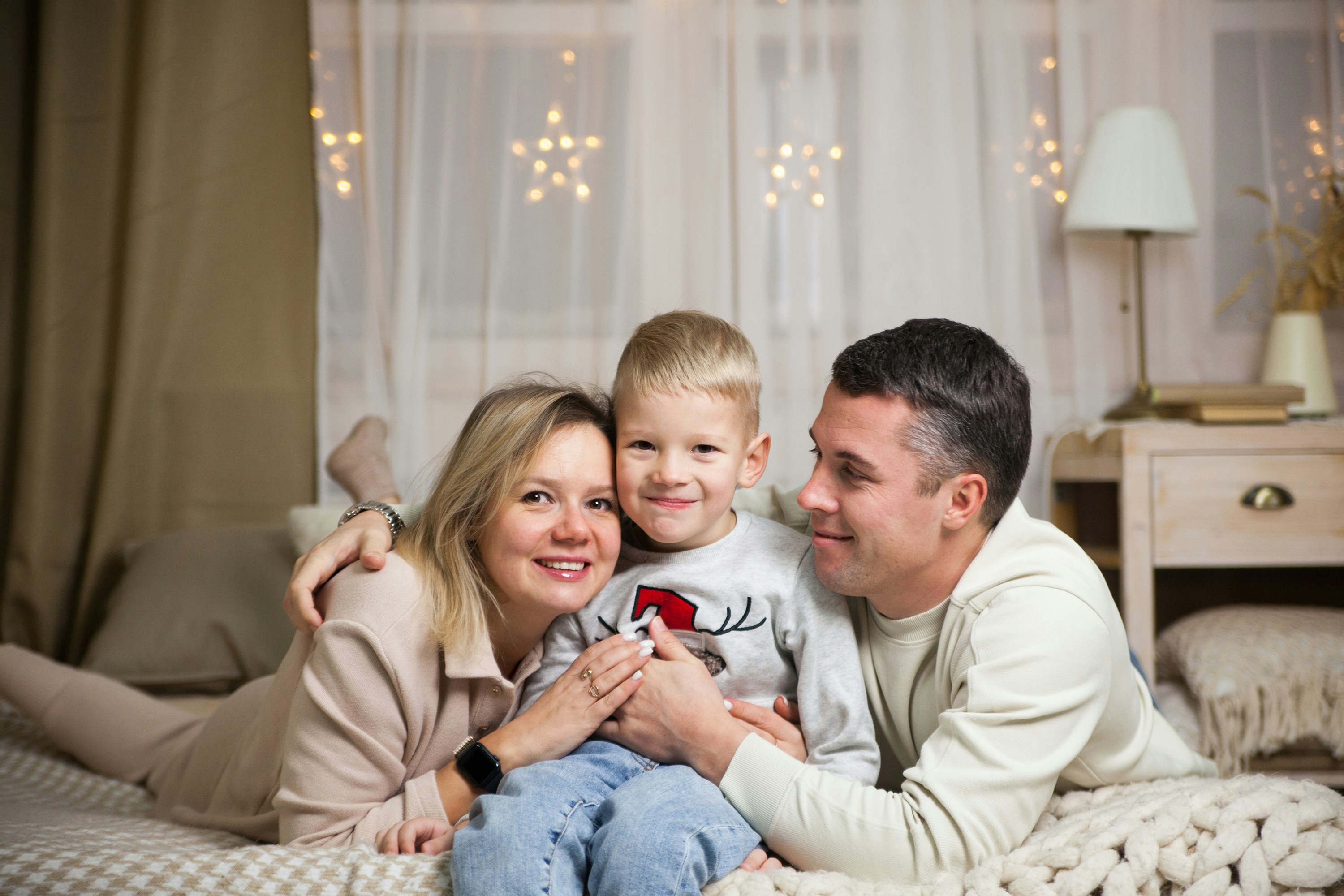 Doctor examining happy child with mother present